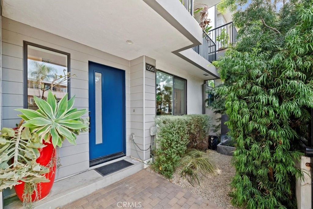 a house with potted plants in front of it