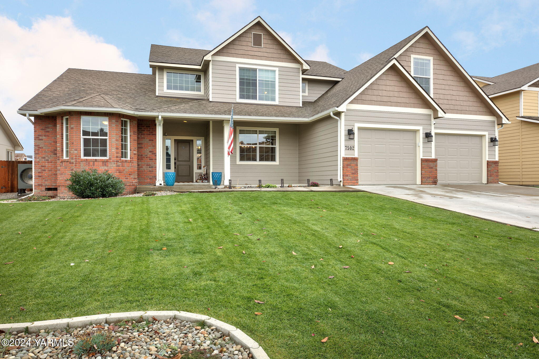 a front view of a house with a yard and porch