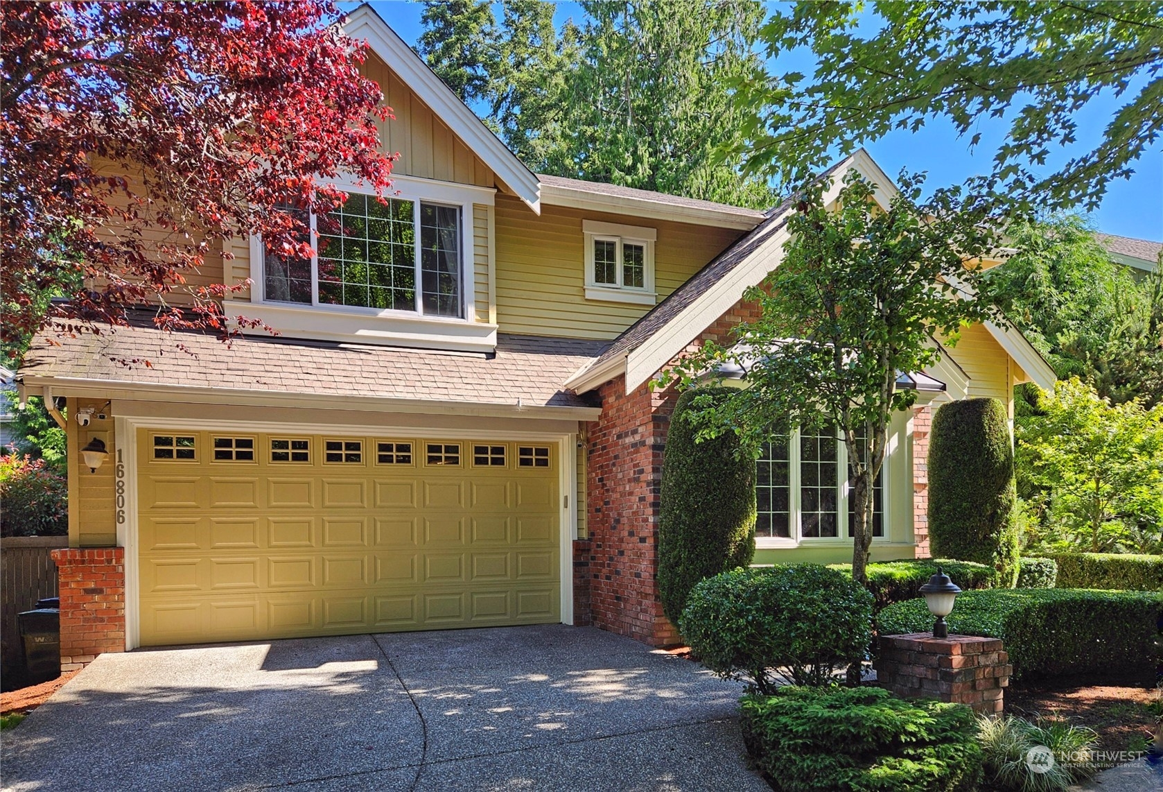 a front view of a house with a garden