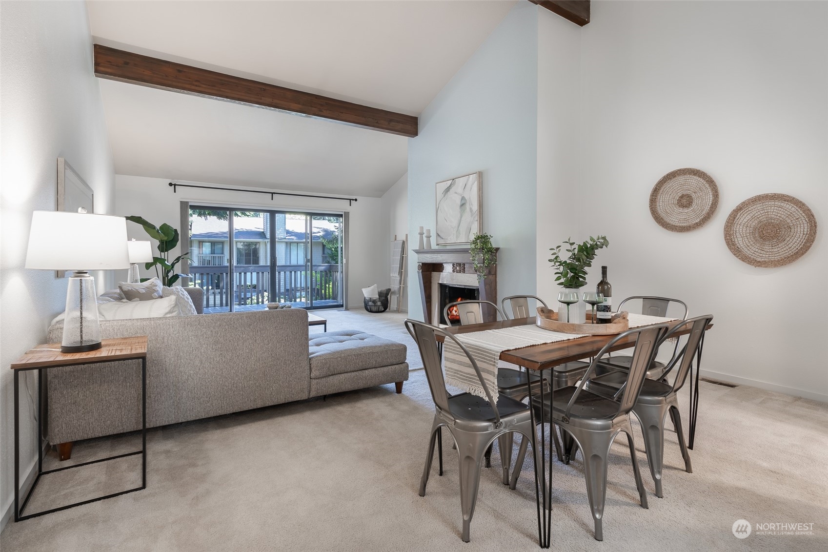 a living room with furniture a fireplace and a table