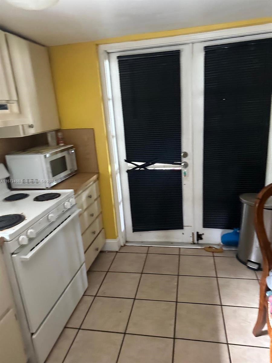 a kitchen with a stove and a refrigerator