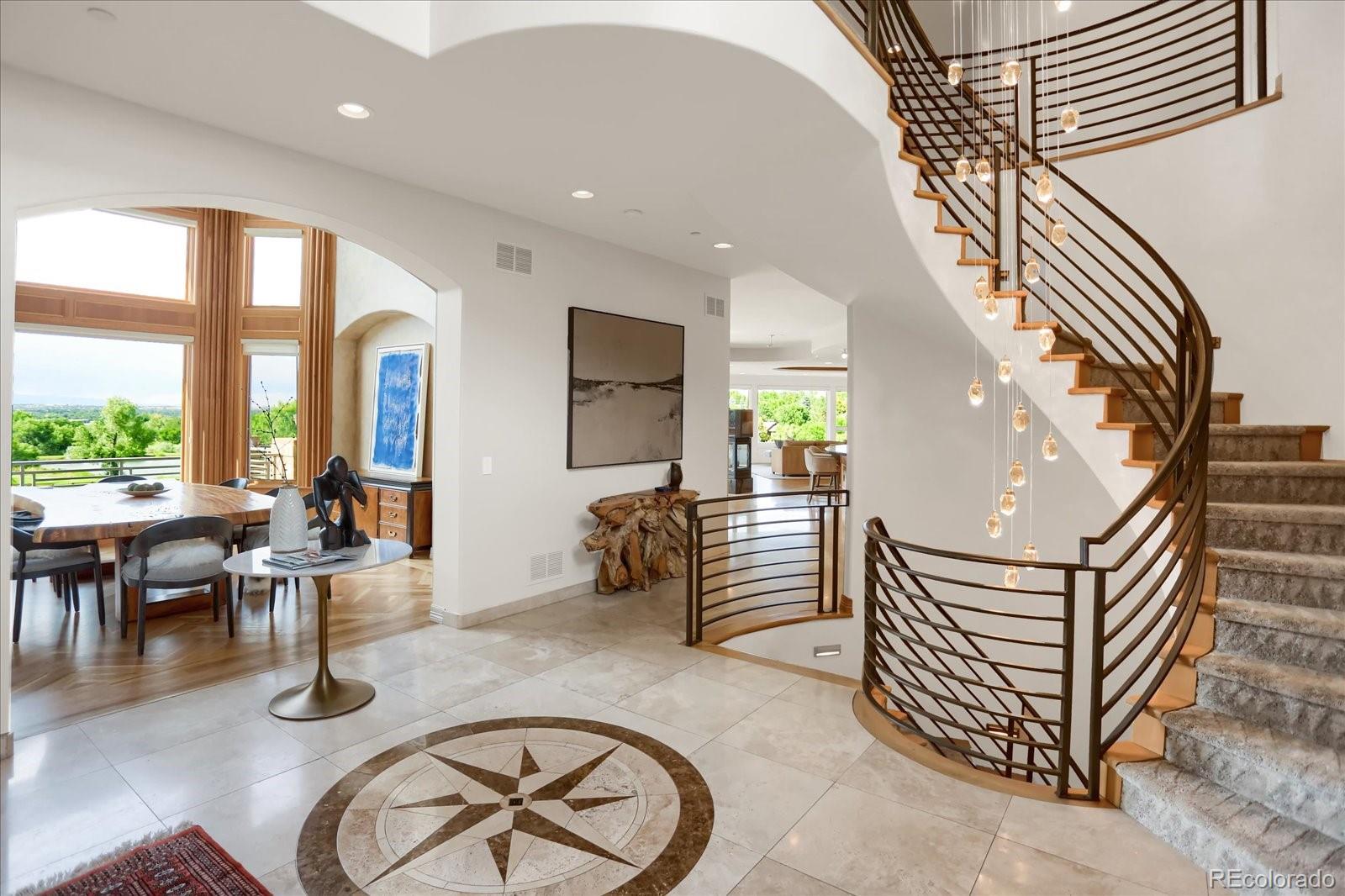 an entryway with wooden floor and windows