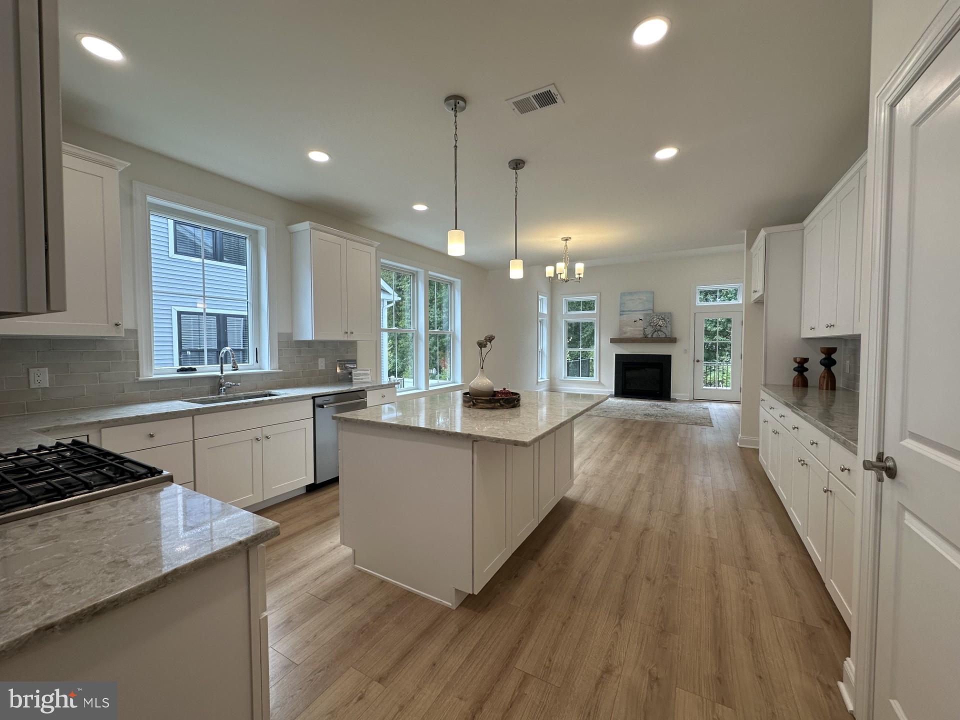 a kitchen with counter top space a sink appliances and cabinets