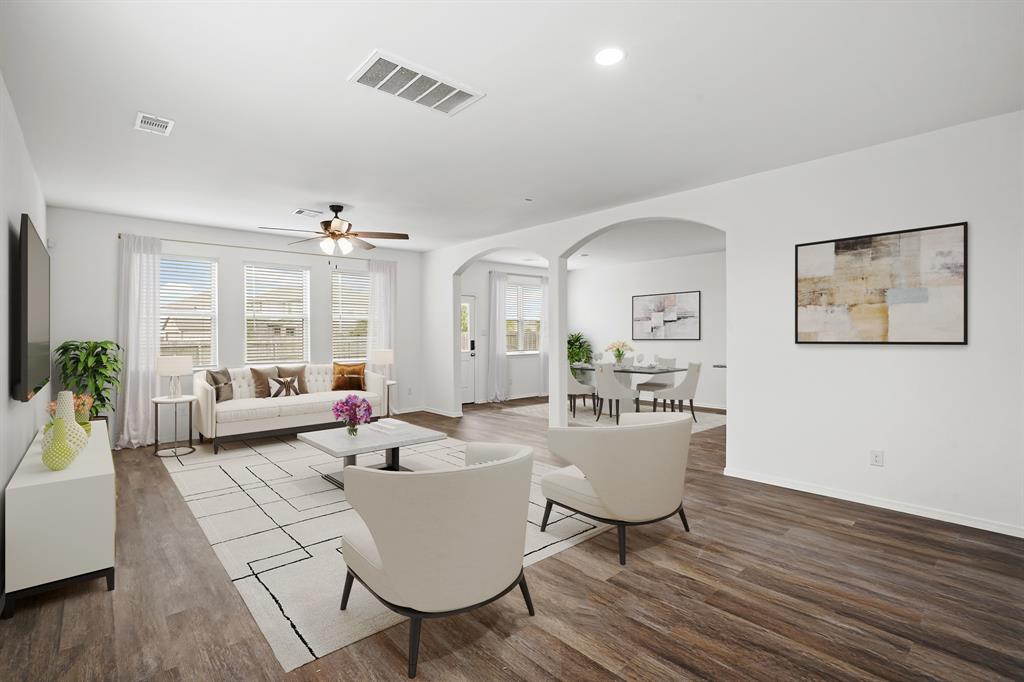 a living room with furniture and wooden floor