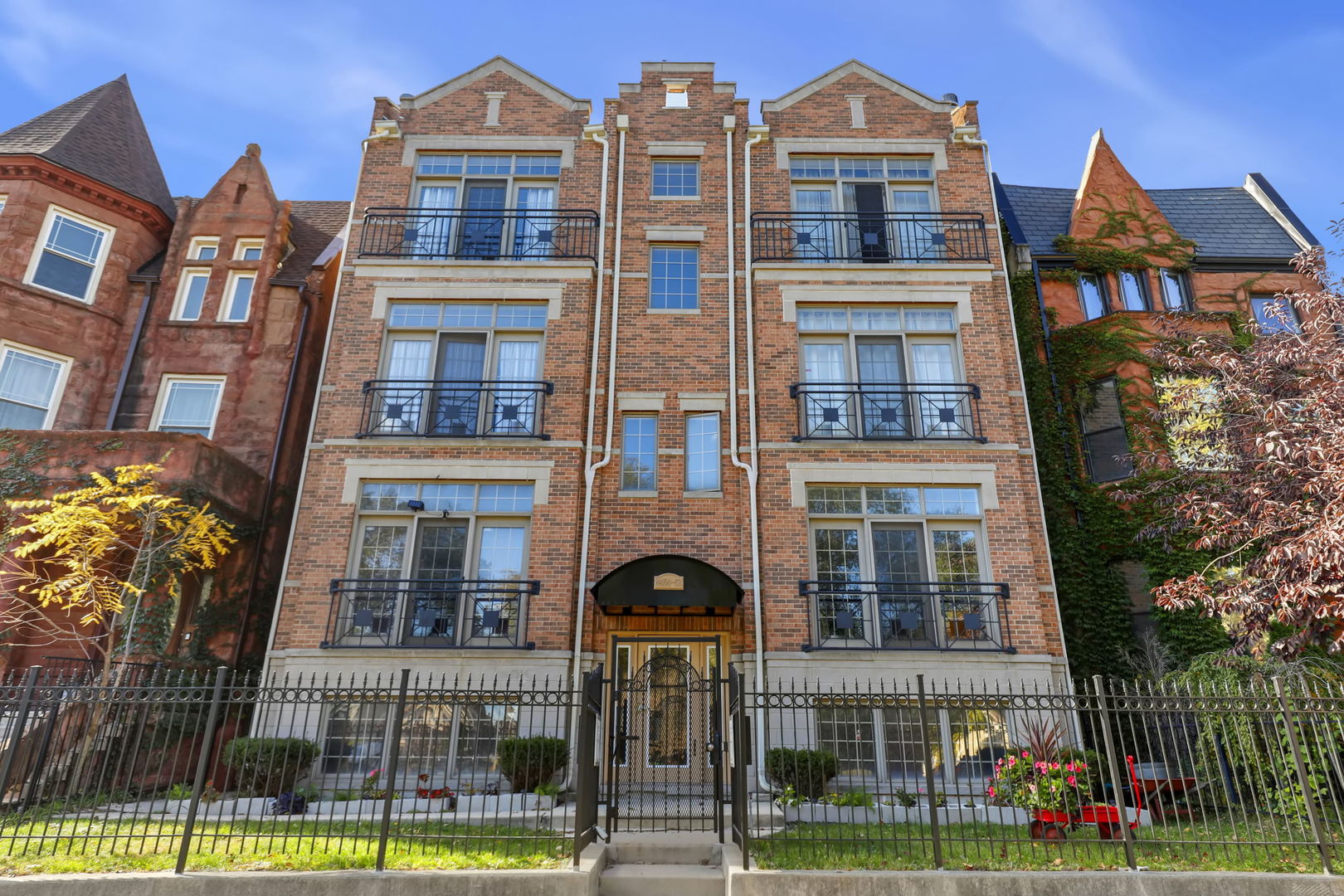 a front view of a residential apartment building with a yard