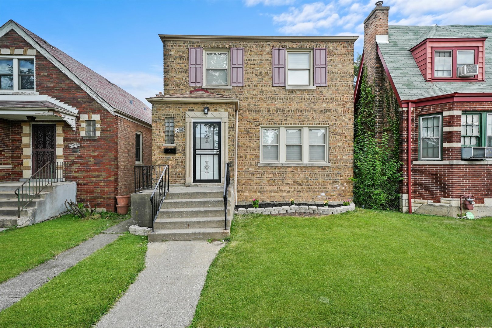 a front view of a house with a garden