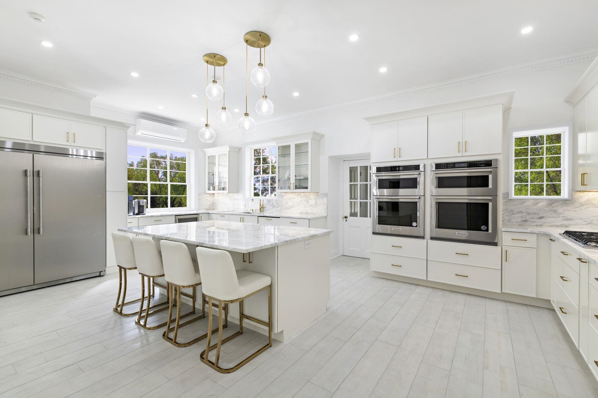 a kitchen with stainless steel appliances granite countertop a stove and a refrigerator