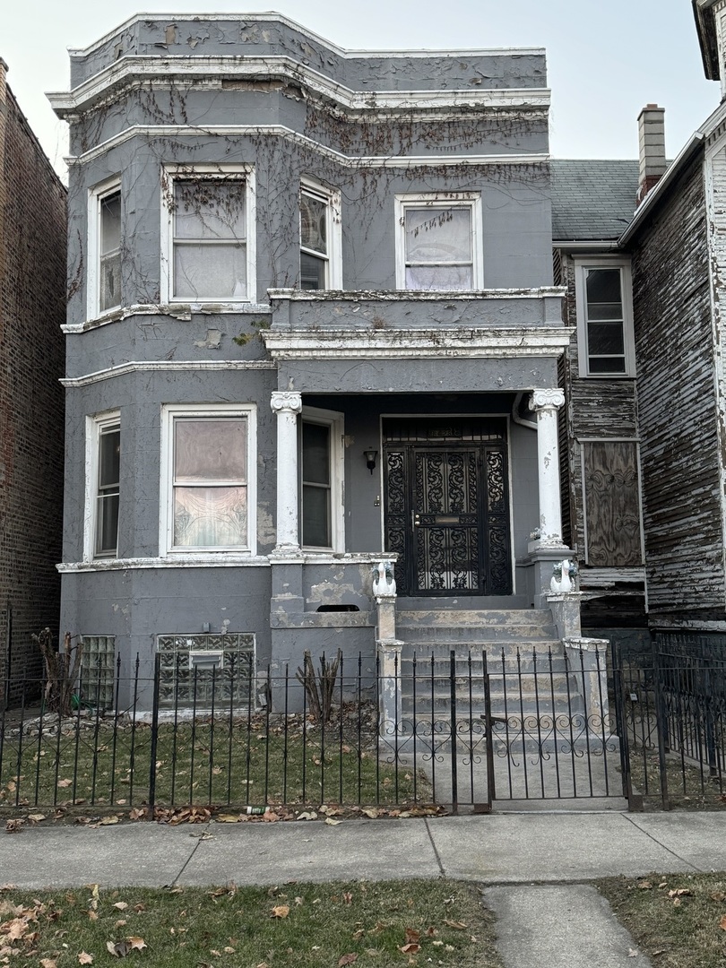 a view of a brick house with large windows