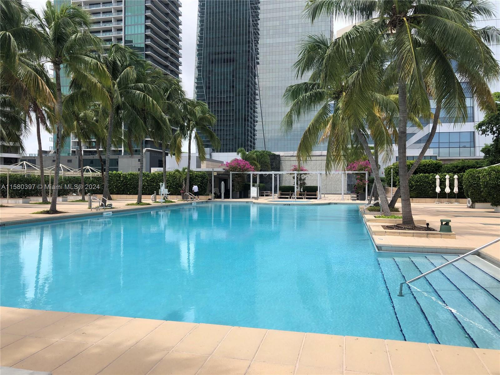 a swimming pool with outdoor seating and yard