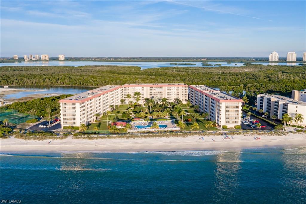 Pre-Hurricanes: Bird's eye view featuring a water view and a beach view