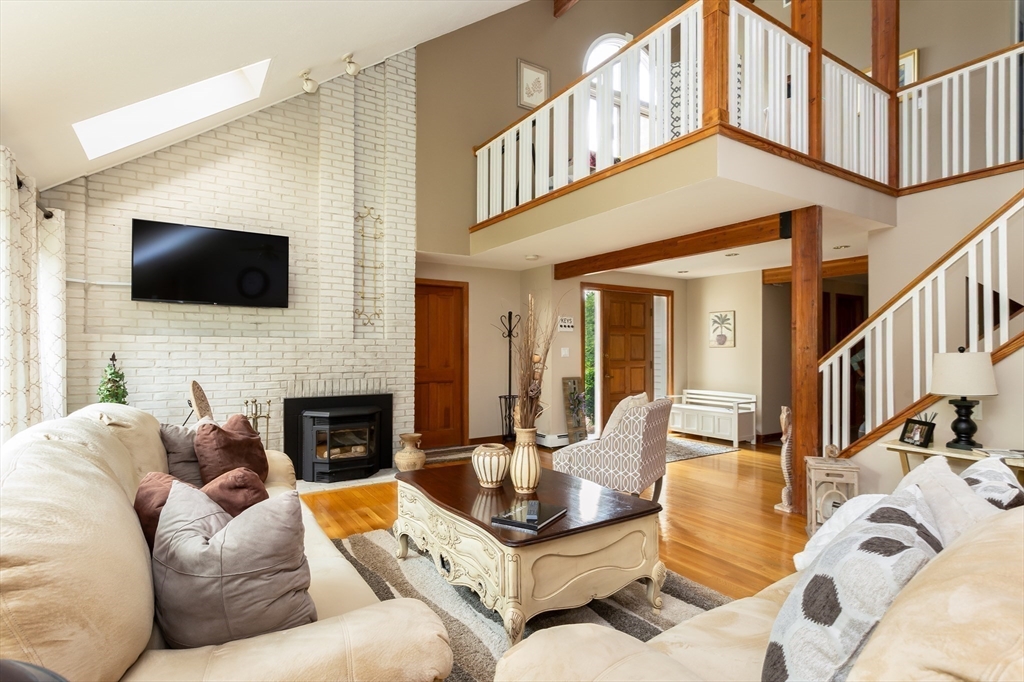 a living room with fireplace furniture and a flat screen tv