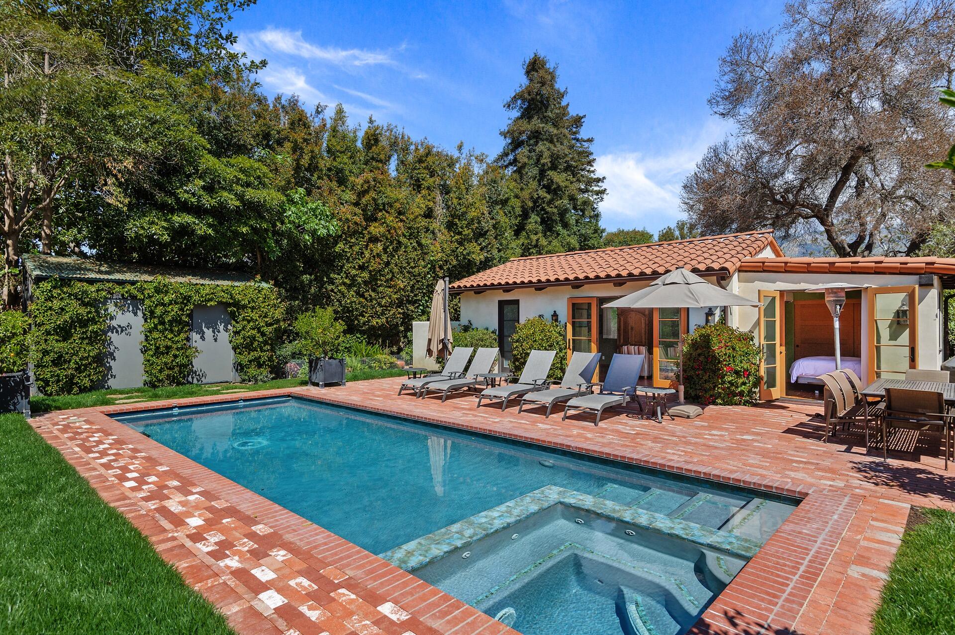 a view of a house with swimming pool and sitting area