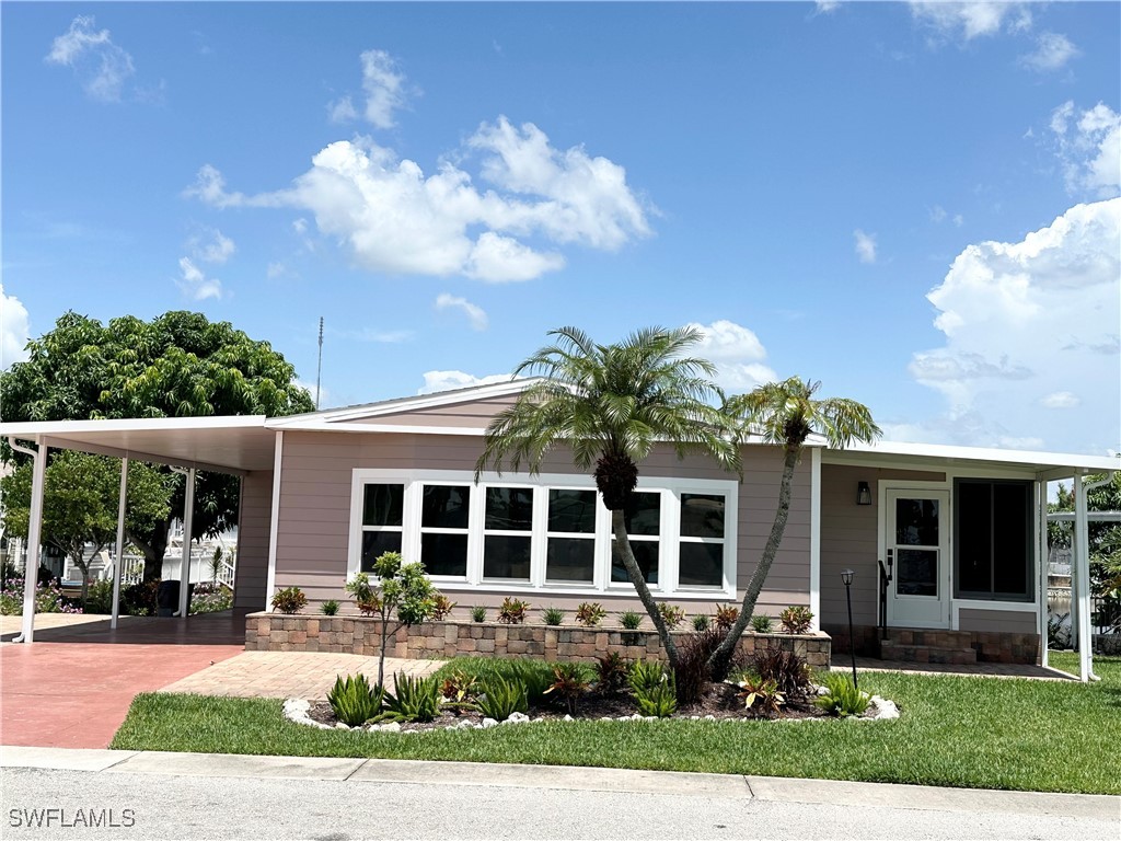 a front view of a house with garden and porch