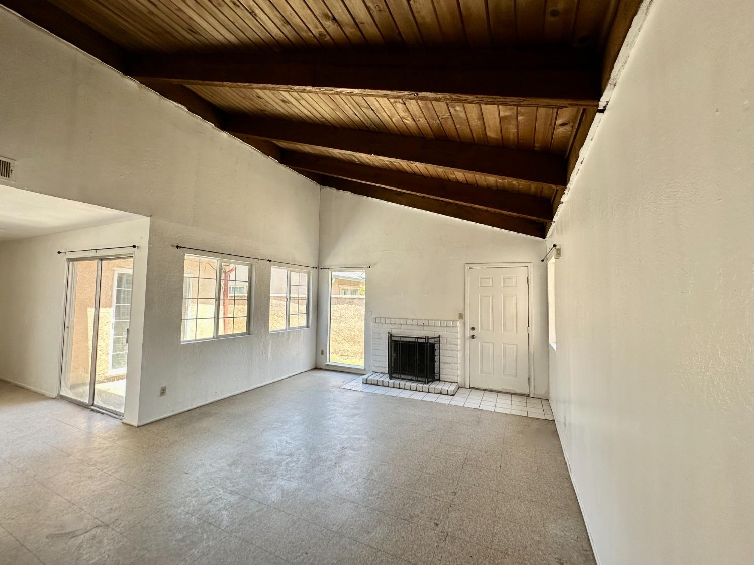 a view of empty room with a fireplace