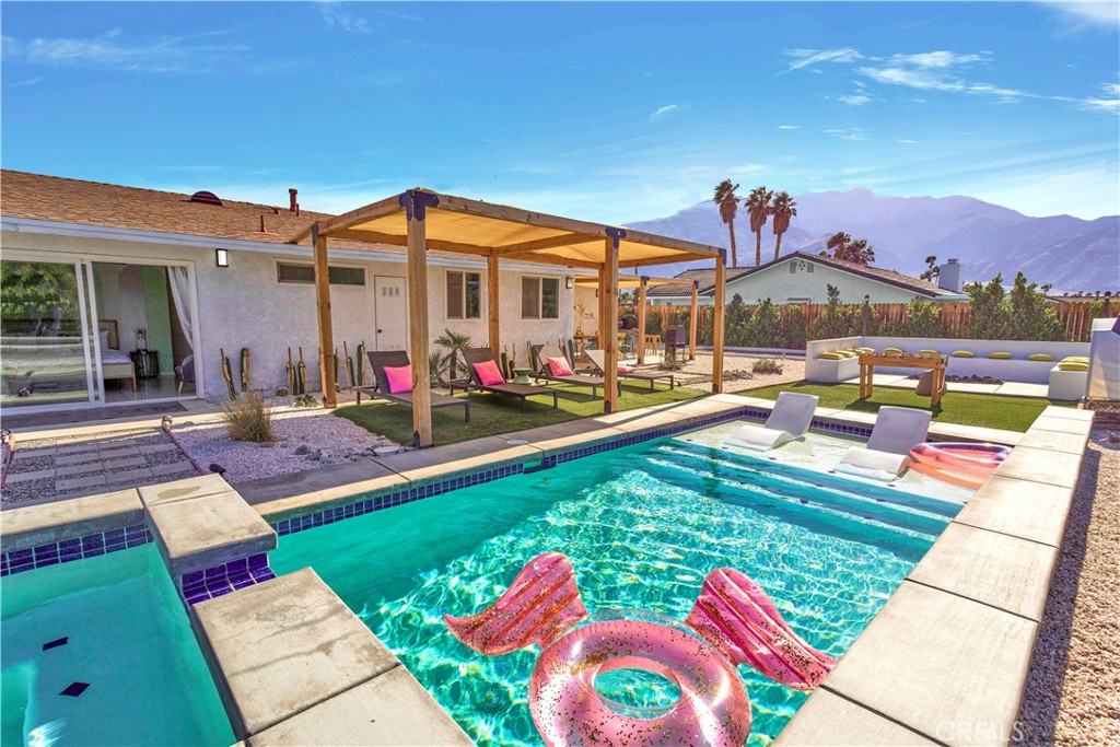 a view of swimming pool with seating area and furniture