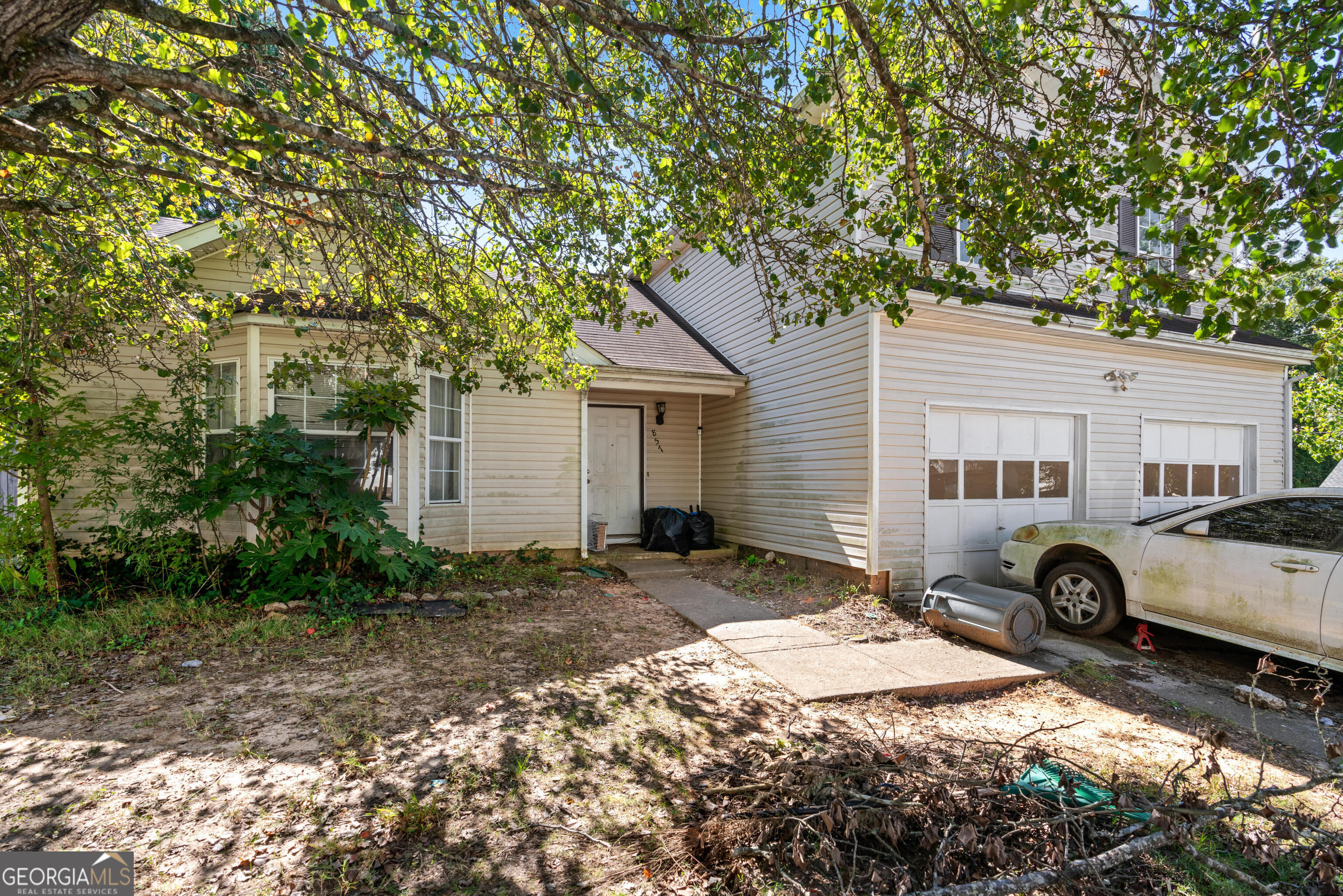 a front view of a house with parking area