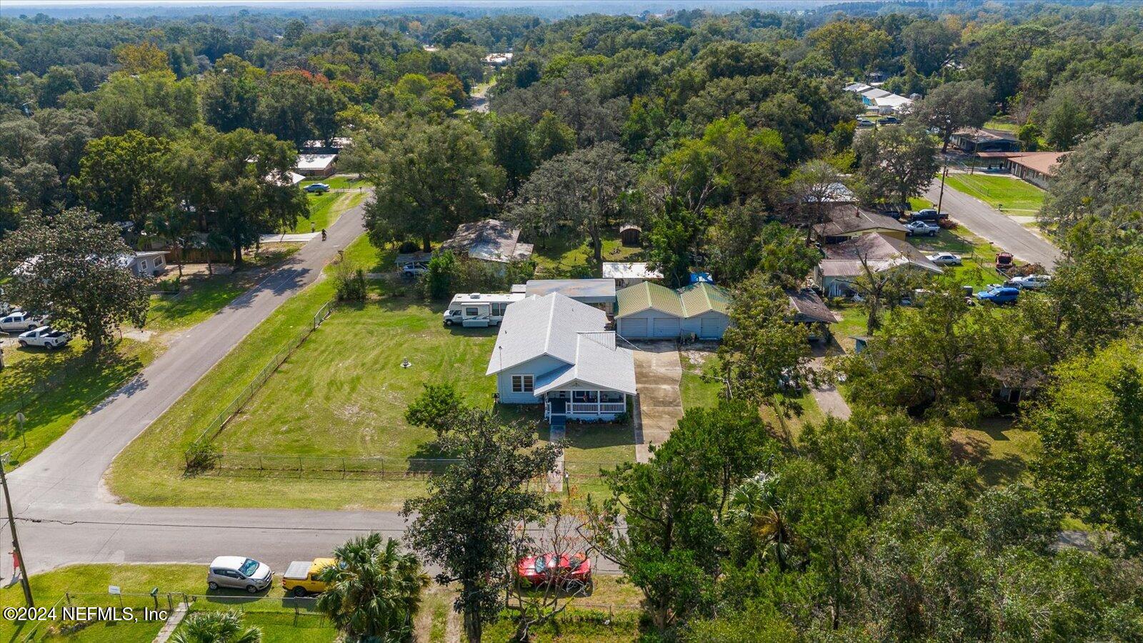 an aerial view of residential house with outdoor space and swimming pool