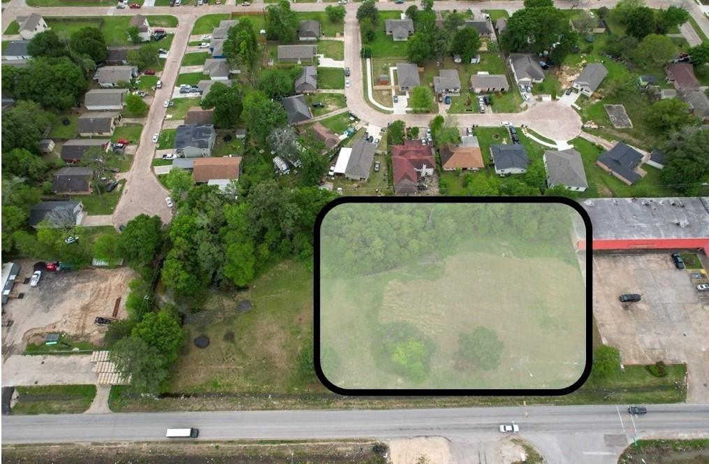 an aerial view of a residential houses with outdoor space and street view