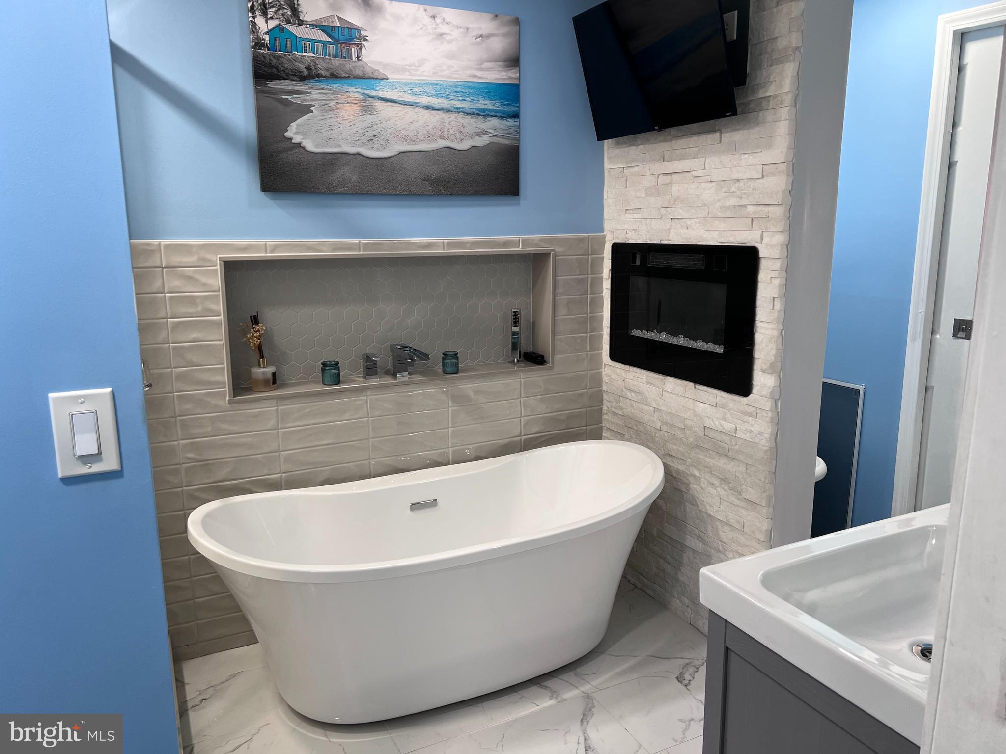 a white bath tub sitting in a bathroom