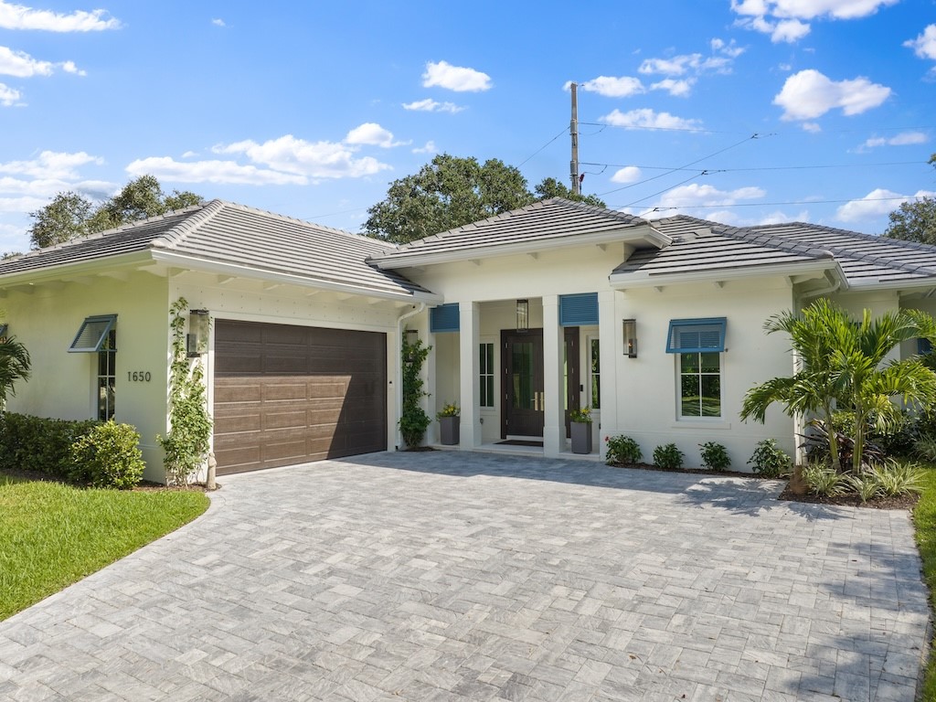 a front view of a house with garden