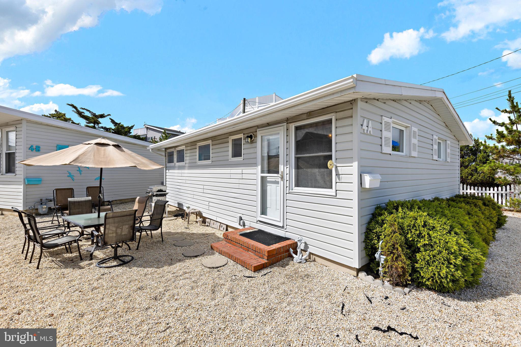 a backyard of a house with yard barbeque oven and outdoor seating