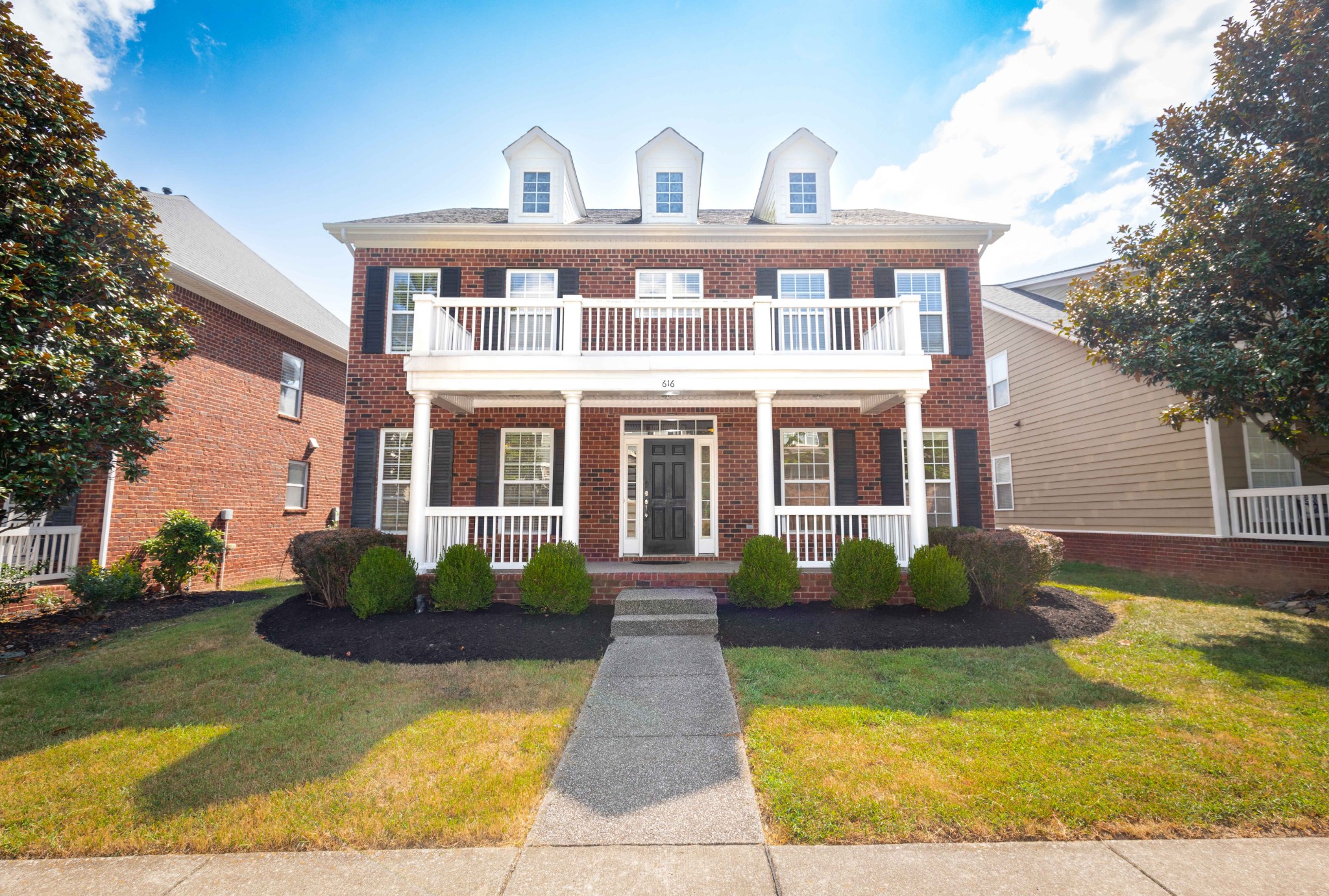 a front view of a house with garden