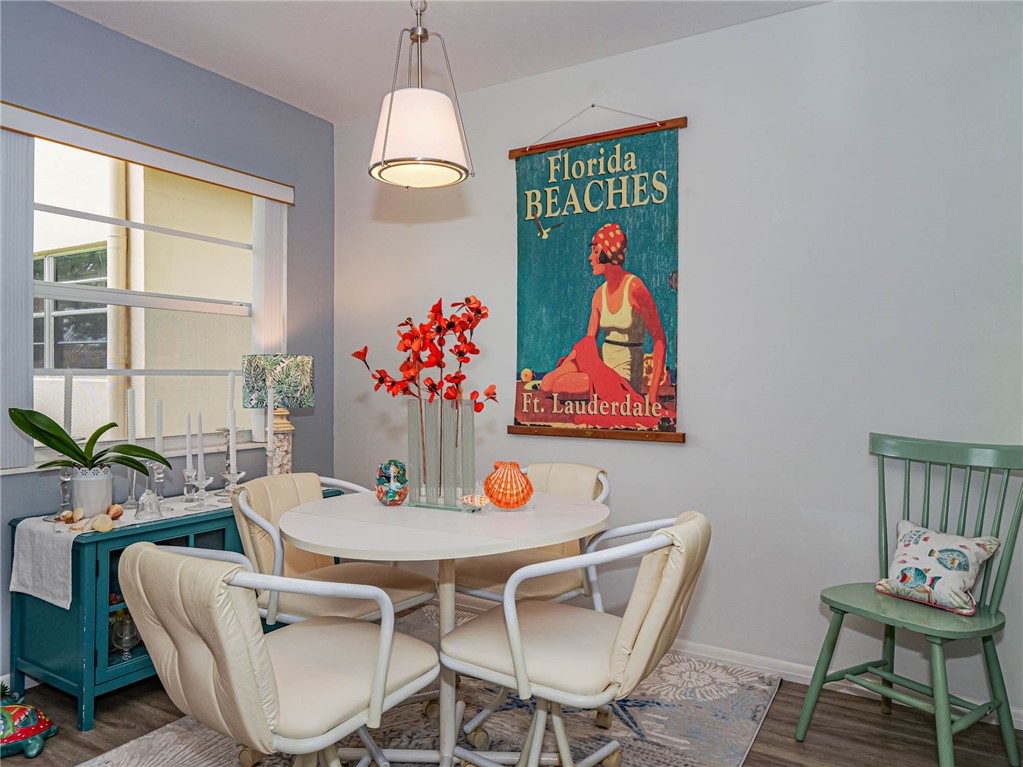 a dining room with furniture a kitchen view and a chandelier