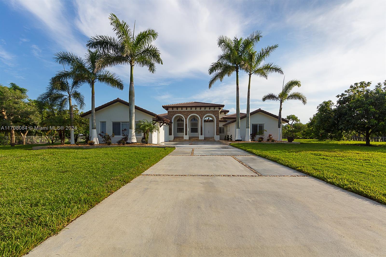 a front view of house with yard and green space