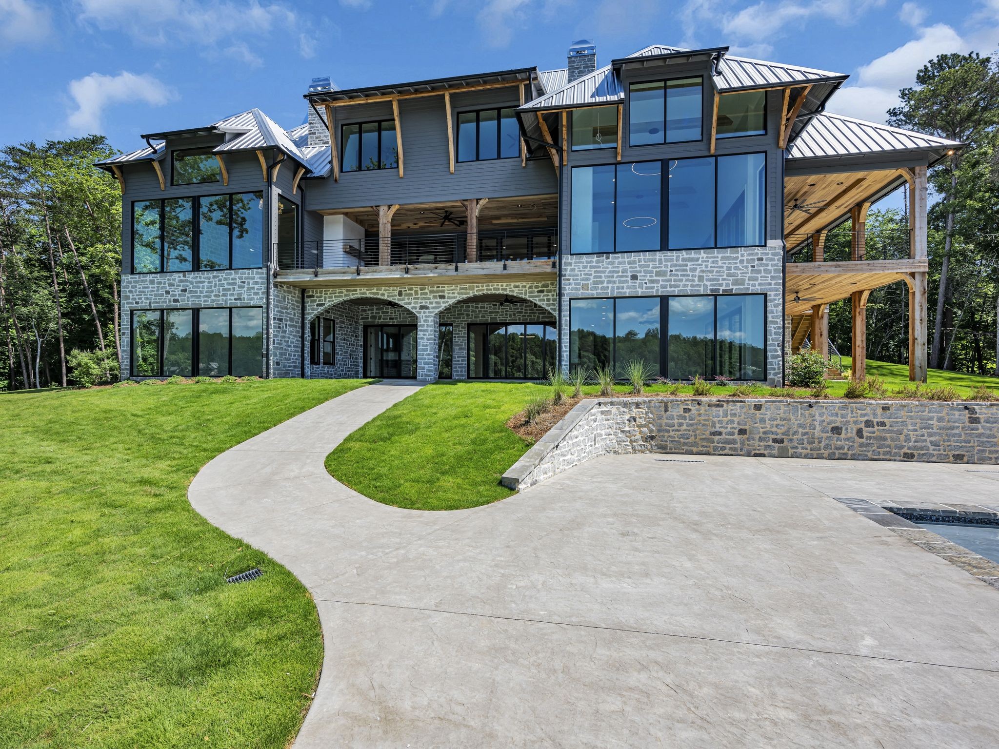 a view of a big house with a yard and plants