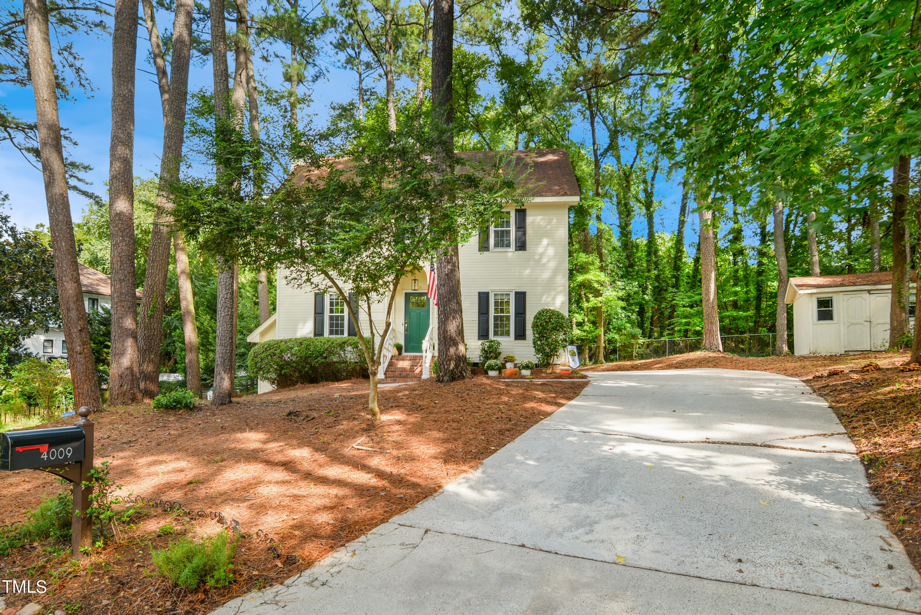 a view of a house with a yard and tree s