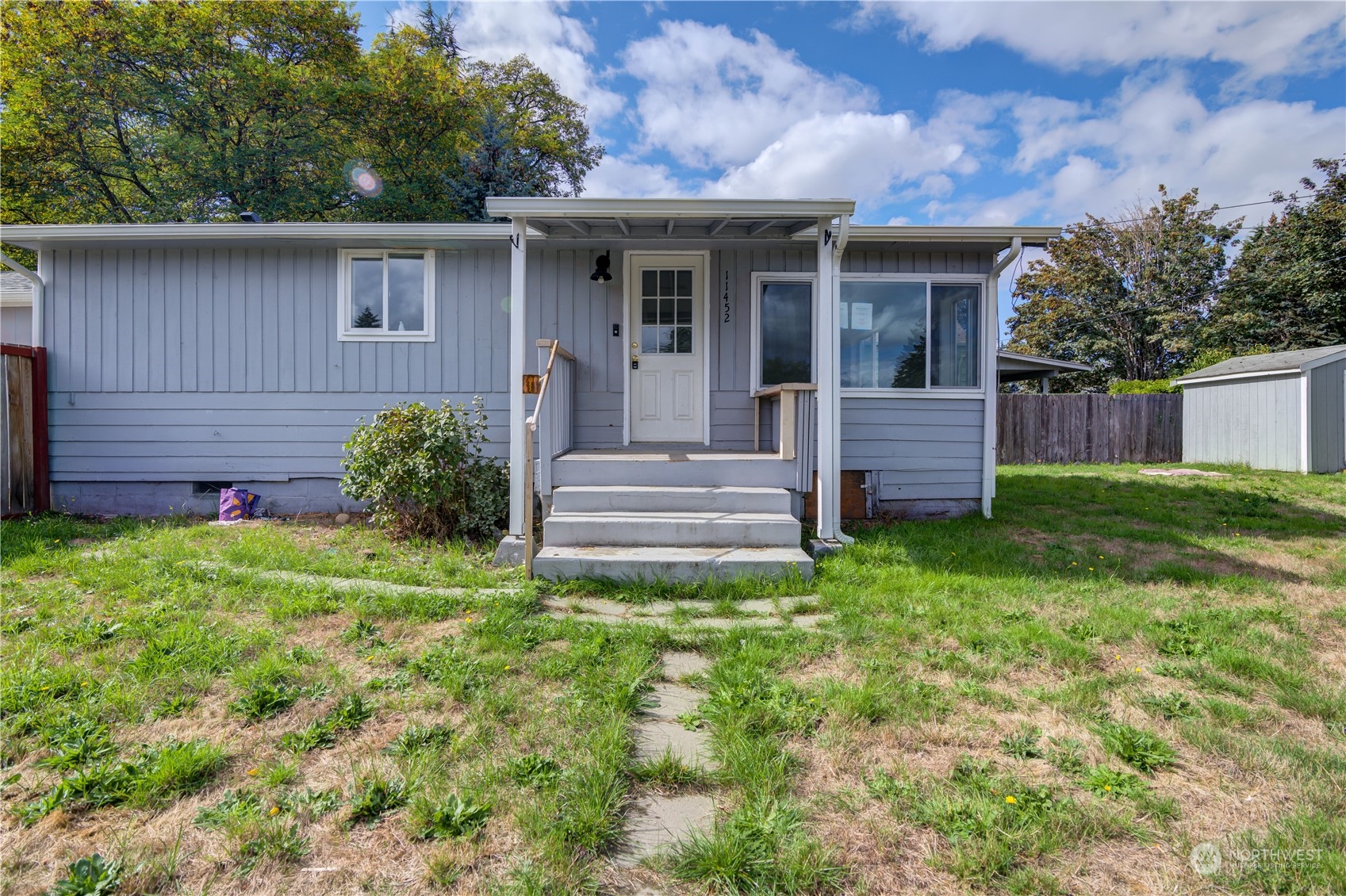 a view of a house with a yard and plants