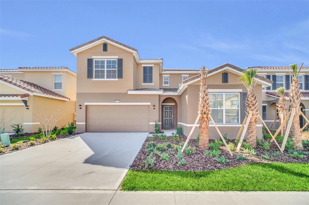 a front view of a house with a yard and garage