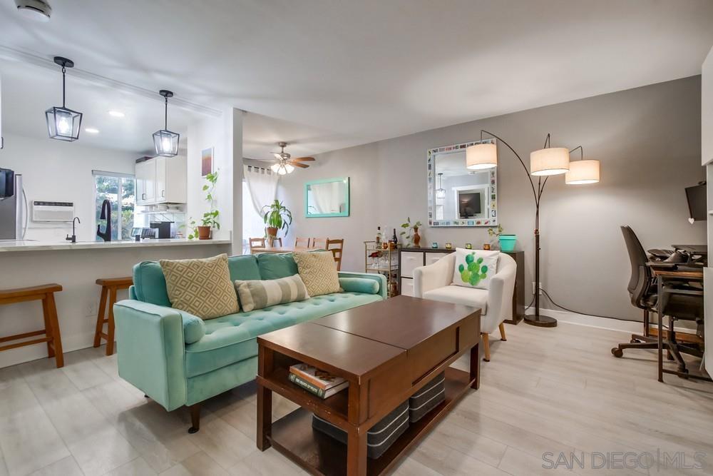 a living room with furniture and a piano