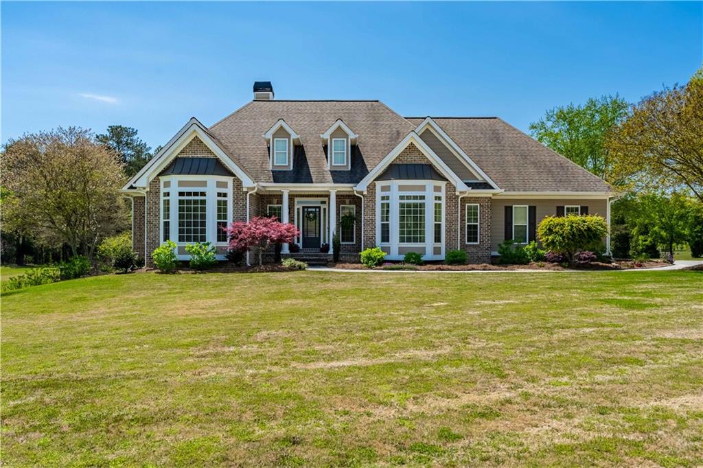 a front view of a house with a garden