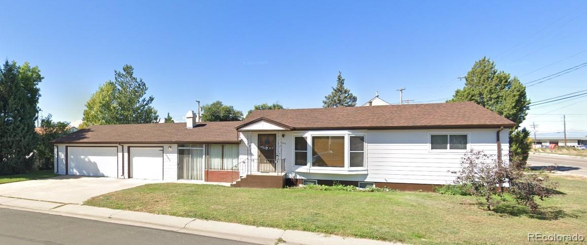 a front view of a house with a garden and yard