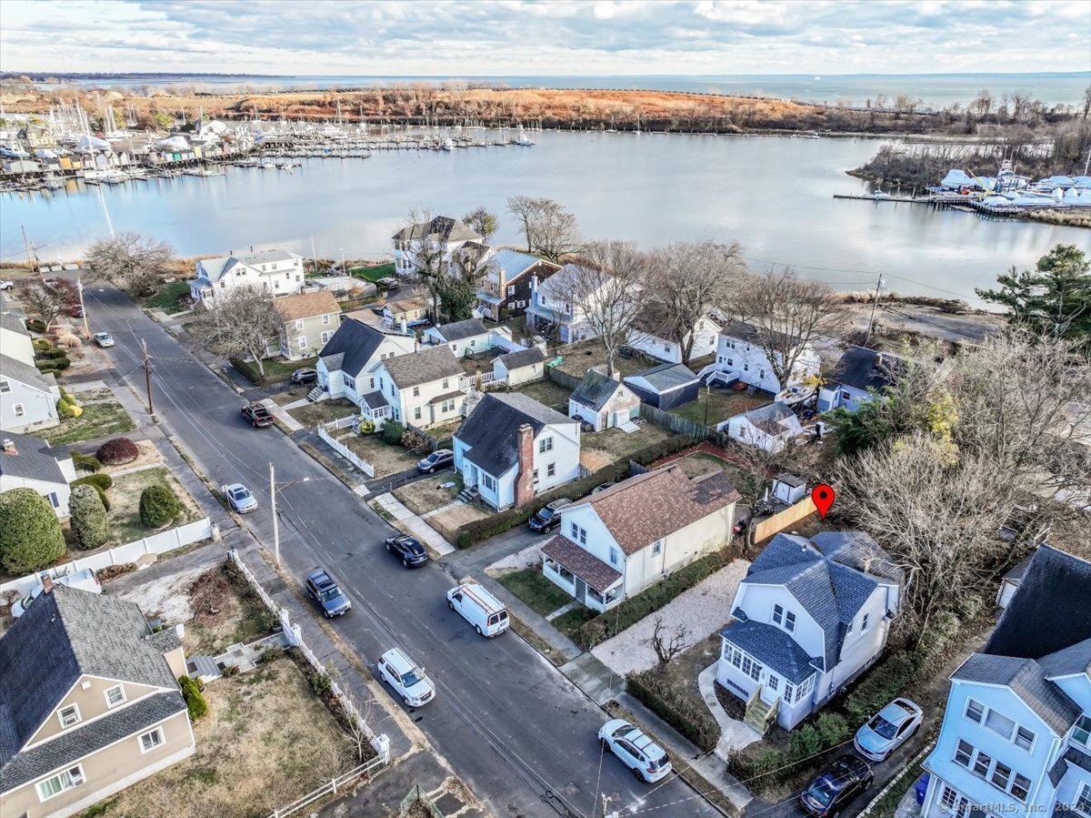 an aerial view of a residential building with outdoor space and lake view