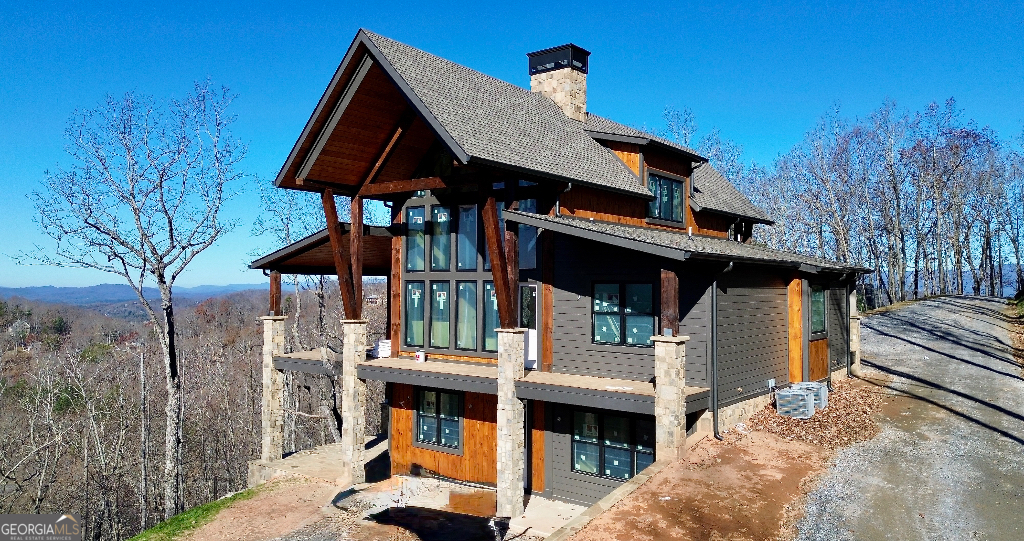 a view of house with outdoor space and sitting area