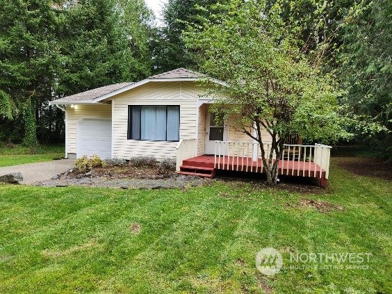 a backyard of a house with wooden deck and barbeque oven