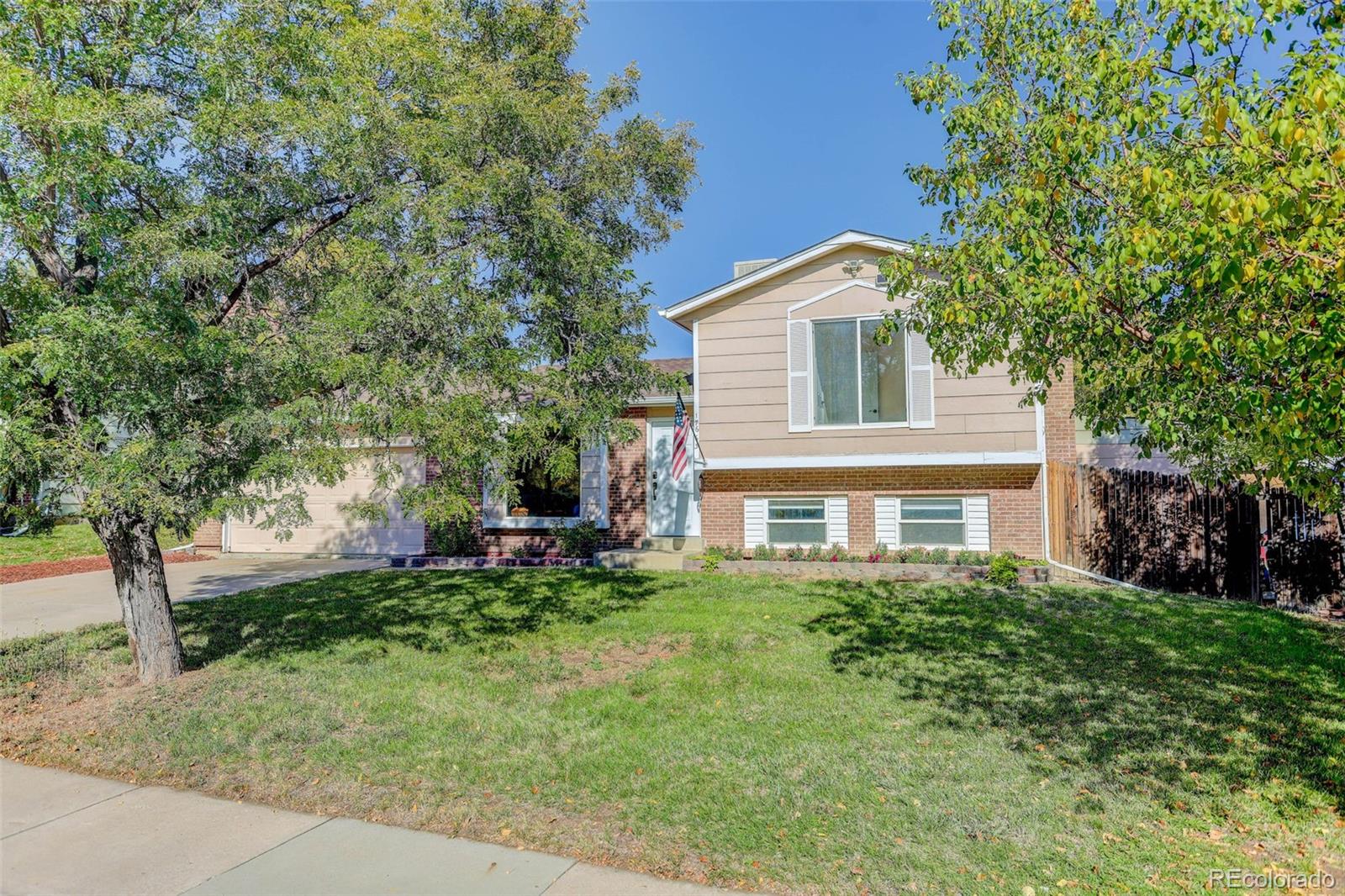 a house that has a tree in front of the house