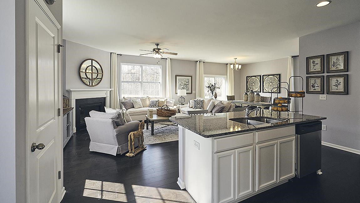 a kitchen with a sink stove and view living room