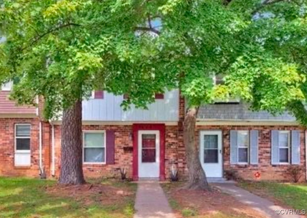 front view of a house with a tree