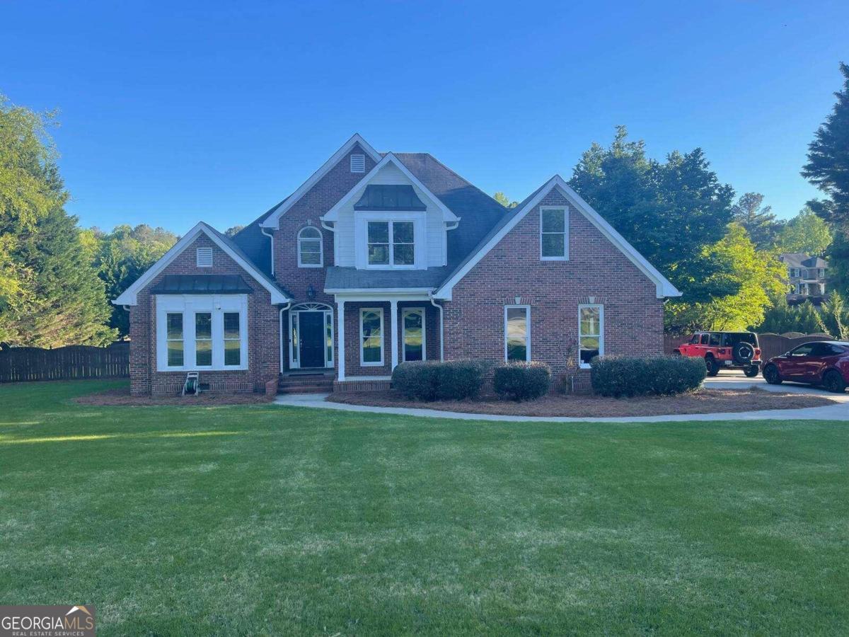 a front view of a house with a garden