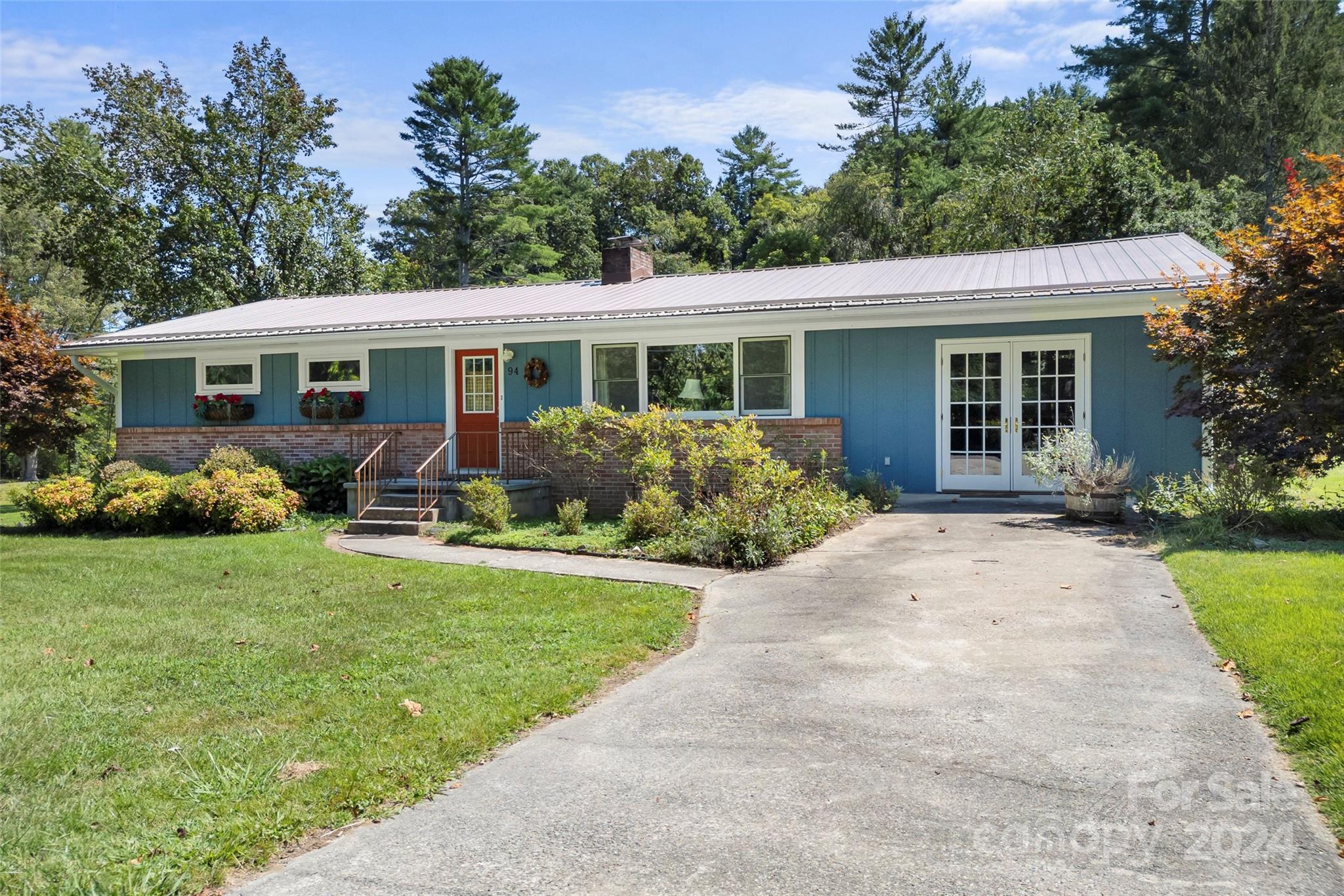 a front view of house with yard and green space