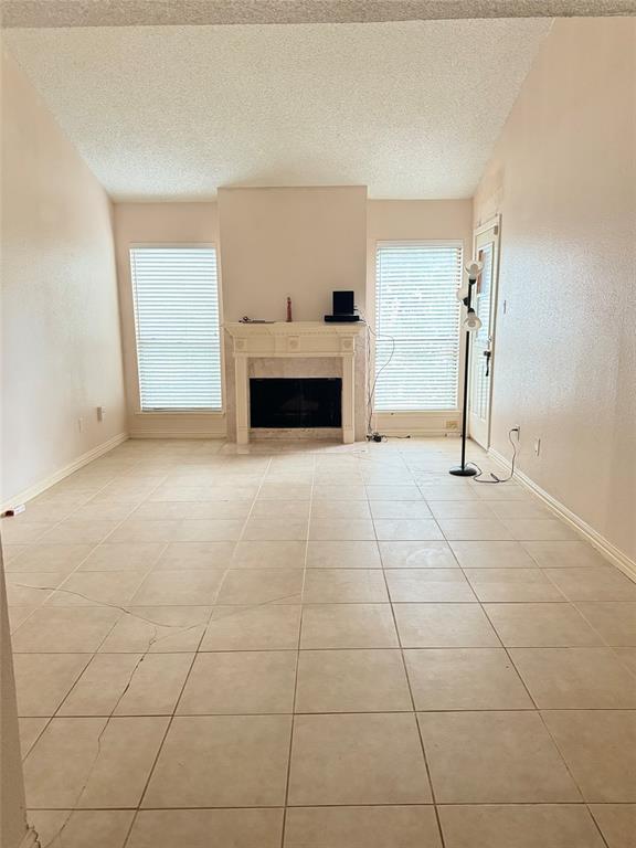 a view of empty room with a fireplace