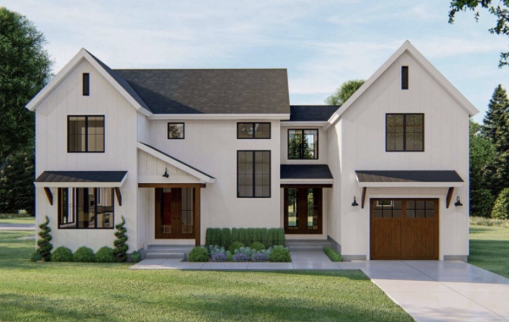 a front view of a house with a yard and garage