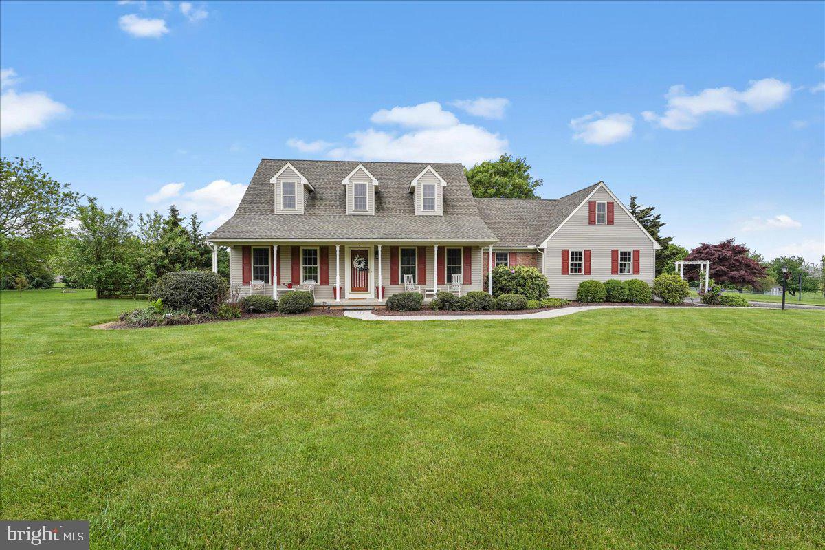 a front view of a house with a garden and yard