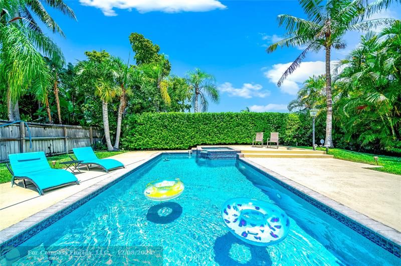 a view of a swimming pool with lounge chairs