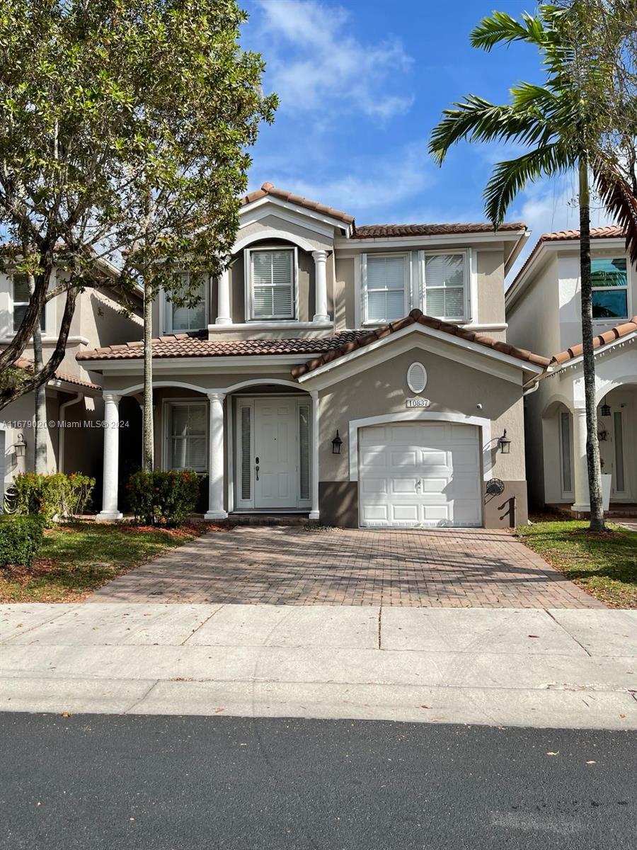 a front view of a house with a yard