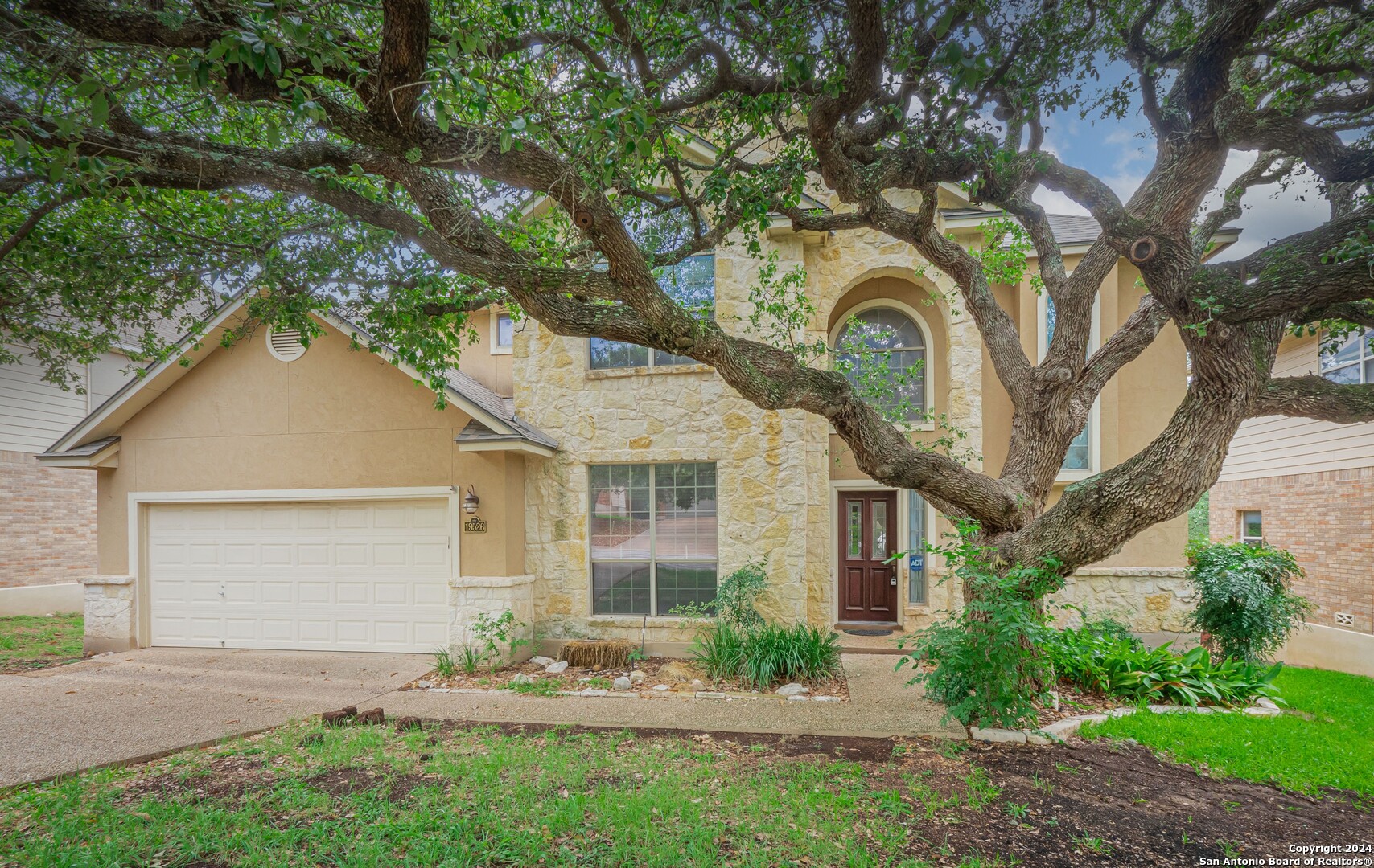 a front view of a house with garden