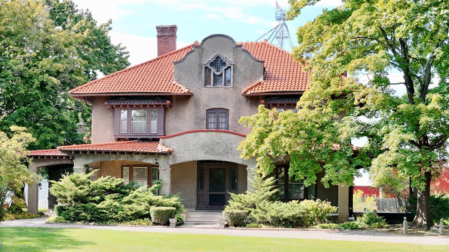 a front view of a house with a garden